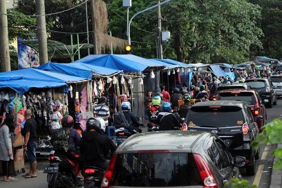 Pedagang menggelar lapak jualannya di bahu Jalan Raya Bogor, Cibinong, Kabupaten Bogor, Jawa Barat, Jumat (29/4).