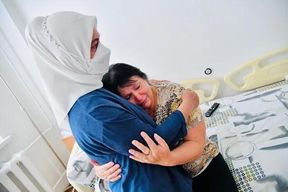 Ibu Negara, Iriana Joko Widodo, memeluk salah satu korban perang yang dirawat di rumah sakit.
