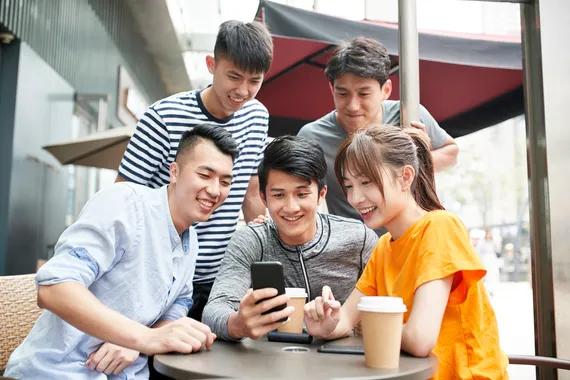 Ilustrasi sekelompok anak muda sedang nonton bareng lewat smartphone (Shutterstock/imtmphoto)